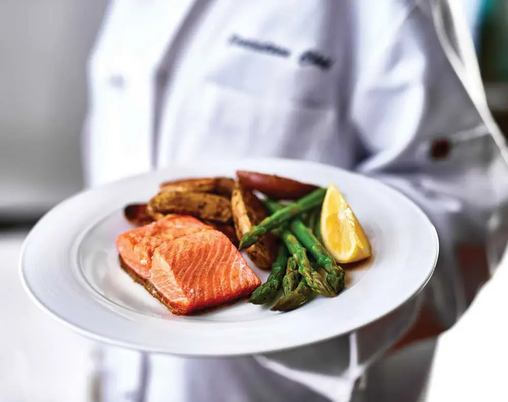 Jordan Oaks Chef Created Meals, chef delivering a finished dish.