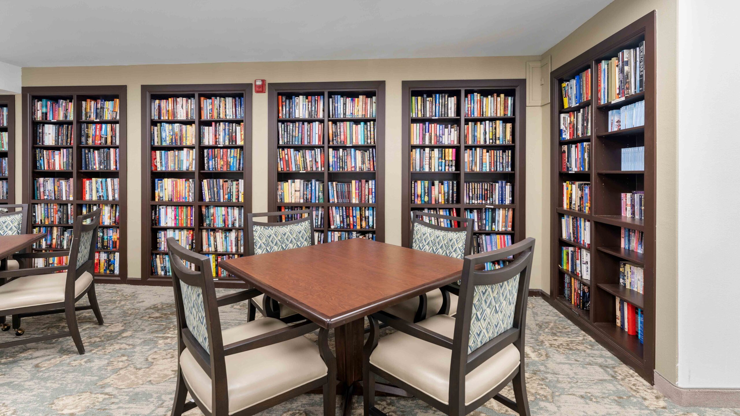 The library at Jordan Oaks with shelves of books and comfortable seating