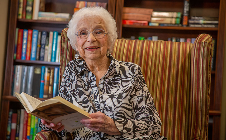 The library at Jordan Oaks with shelves of books and comfortable seating